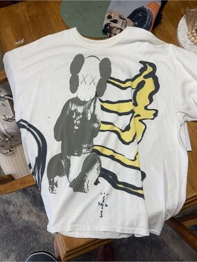 Travis Scott / kaws White Tee with Gray Character & Yellow Accent Graphic